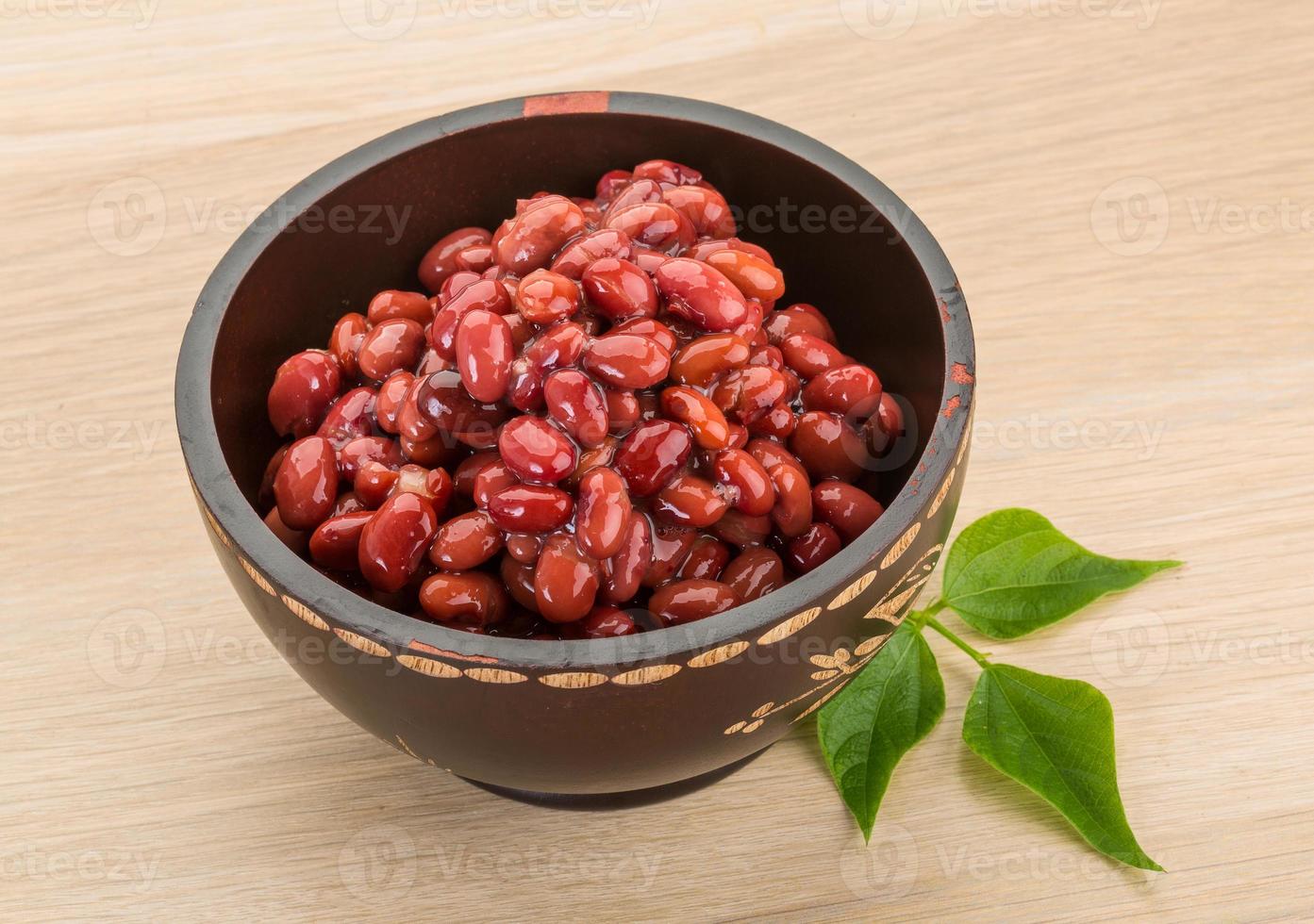 Red beans in a bowl on wooden background photo