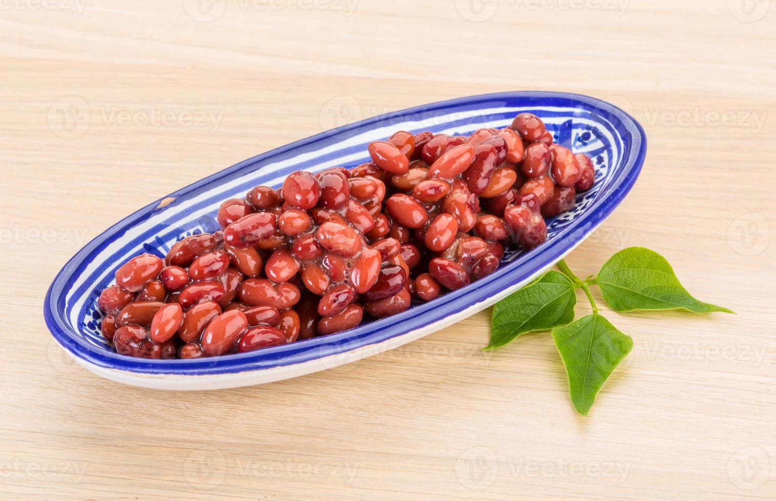 Red beans in a bowl on wooden background photo