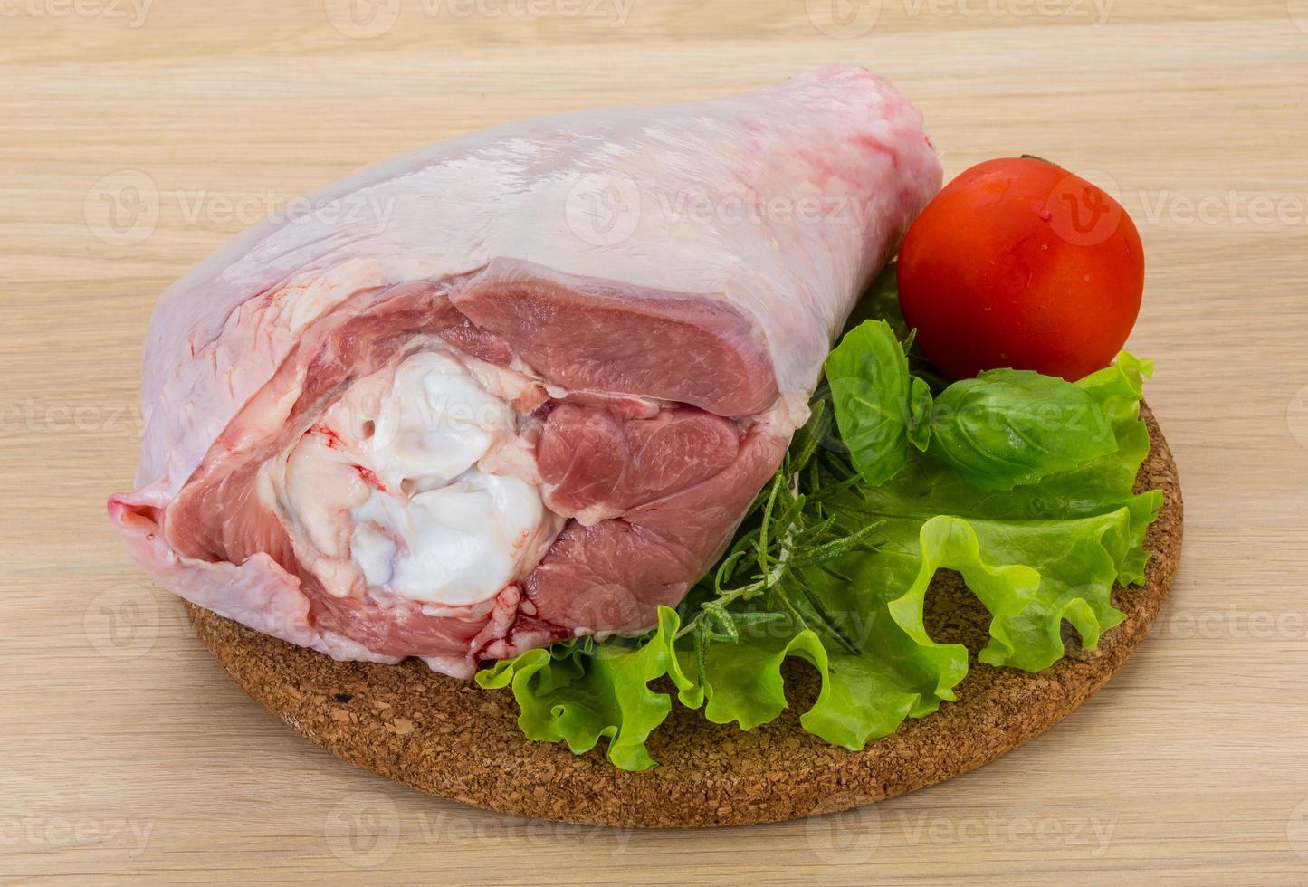 Turkey leg on wooden board and wooden background photo