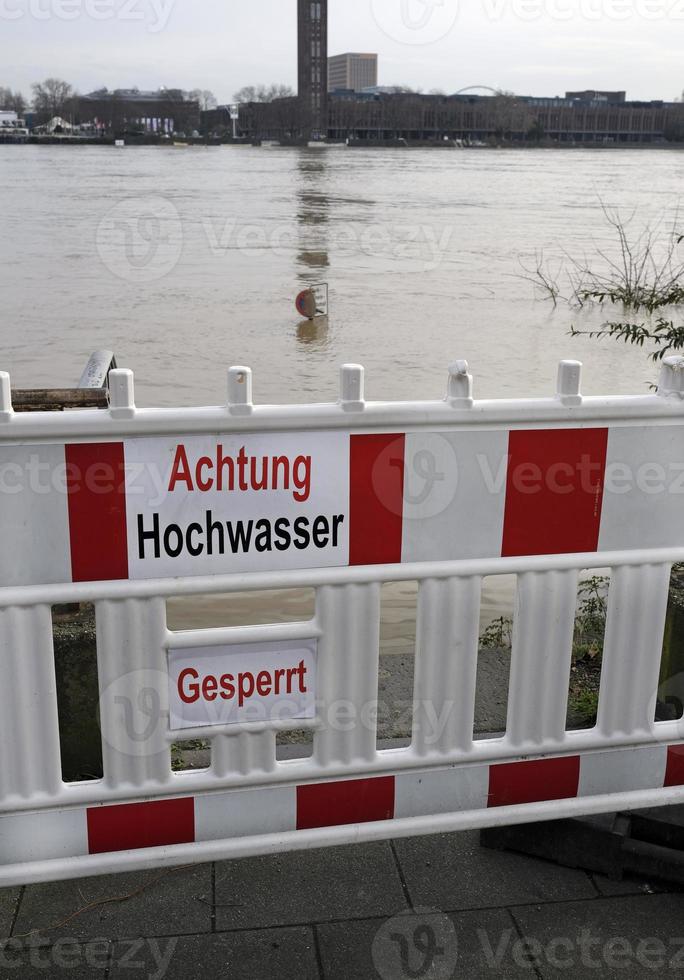 Extreme weather - Warning sign in German at the entrance to a flooded pedestrian zone in Cologne, Germany photo