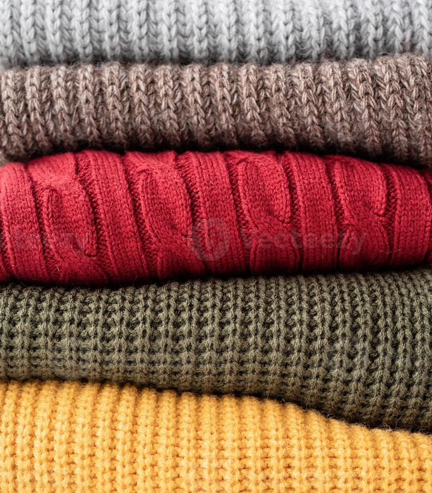 Stack of autumn warm sweaters photo