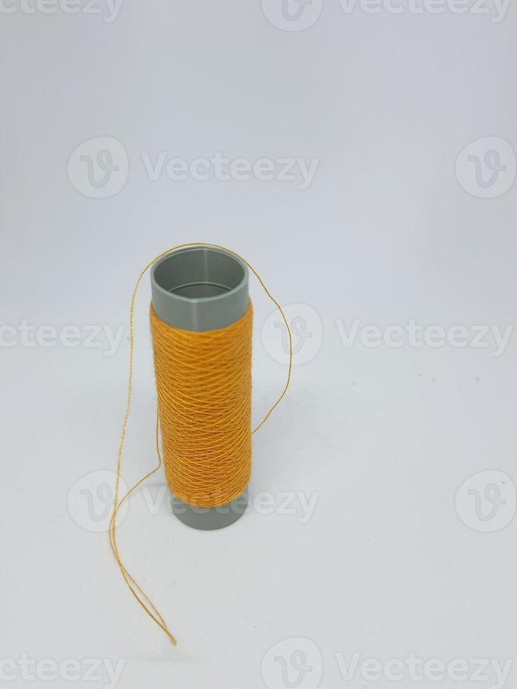 Isolated white photo of a blue sewing thread.