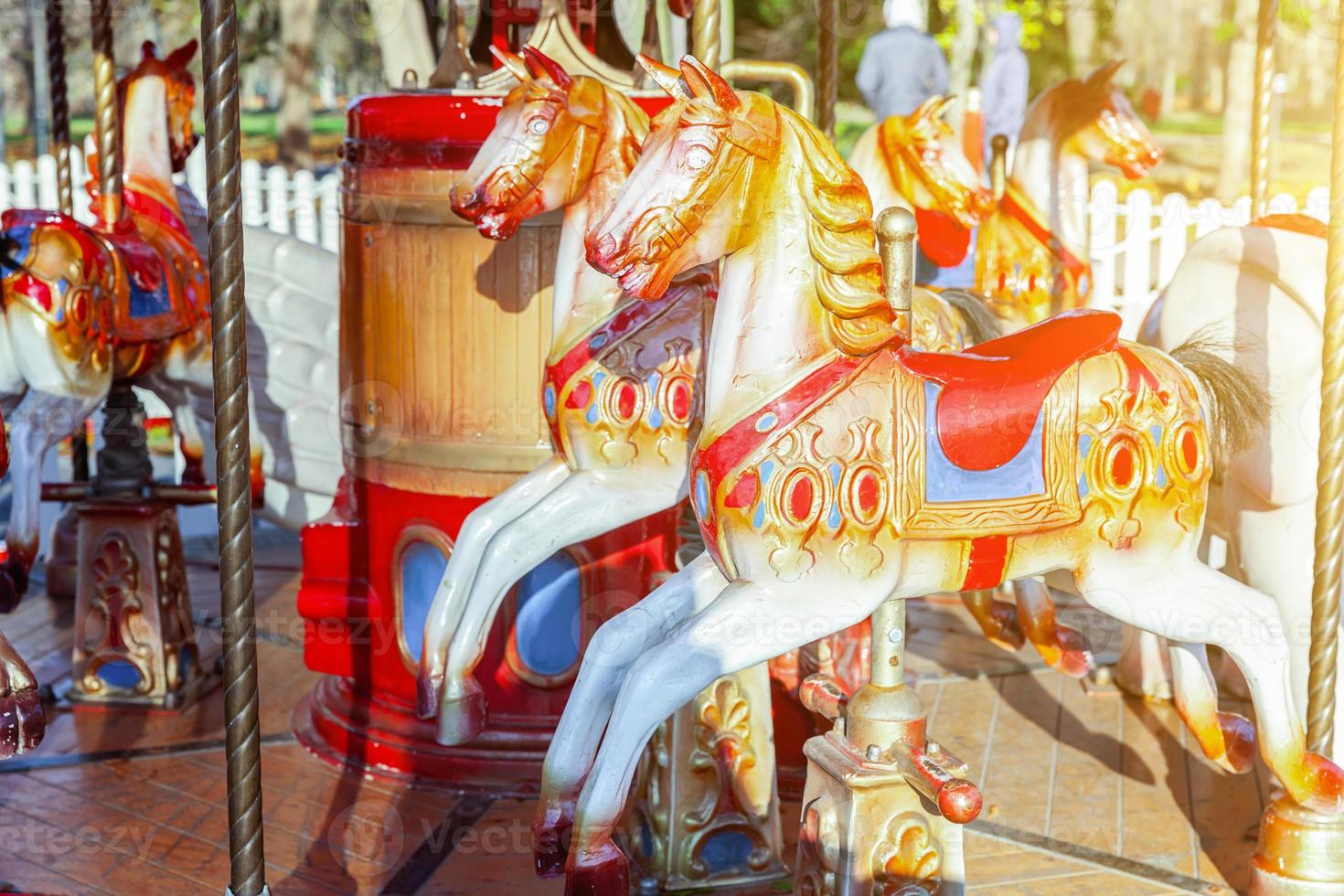 Vintage Merry-Go-Round flying horse carousel in amusement holliday park photo