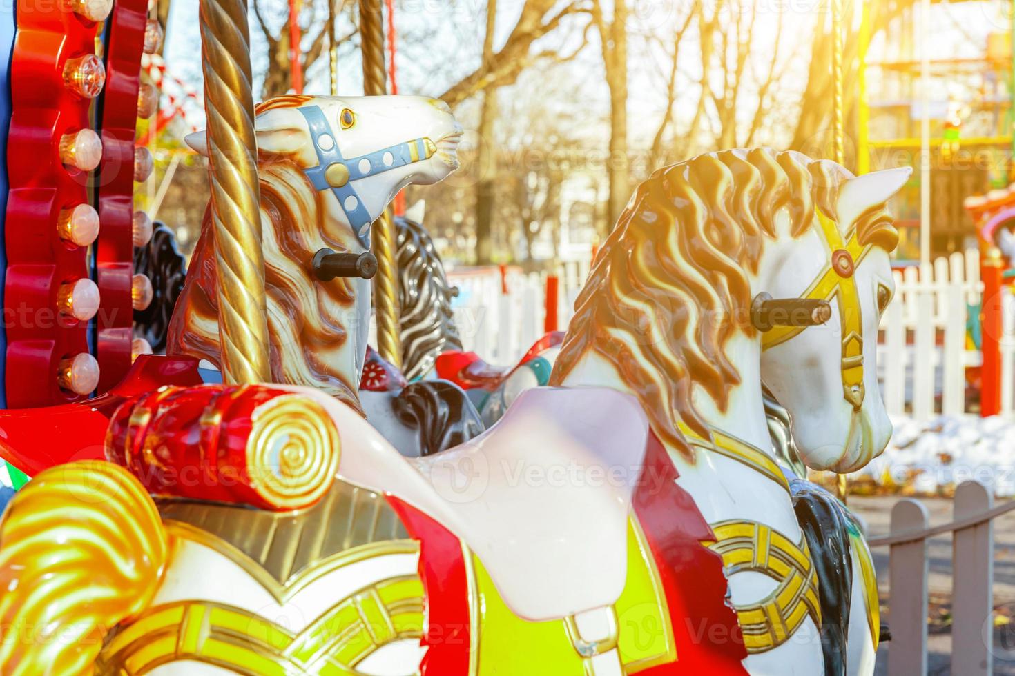 Vintage Merry-Go-Round flying horse carousel in amusement holliday park photo