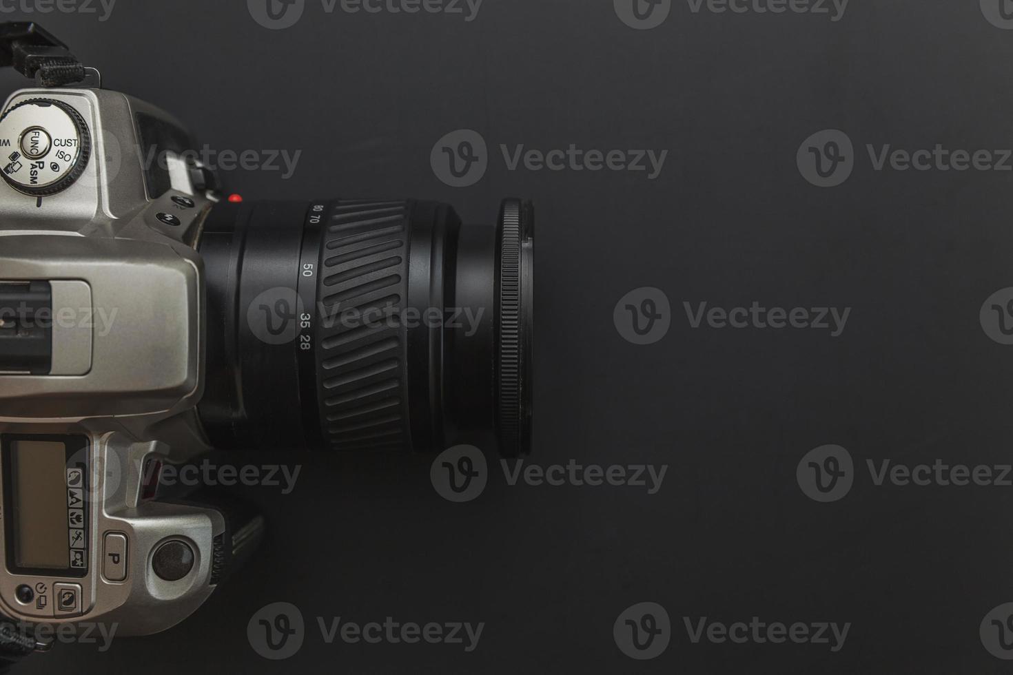 Photographer workplace with dslr camera system on dark black table background. Hobby travel photography concept. Flat lay top view copy space. photo