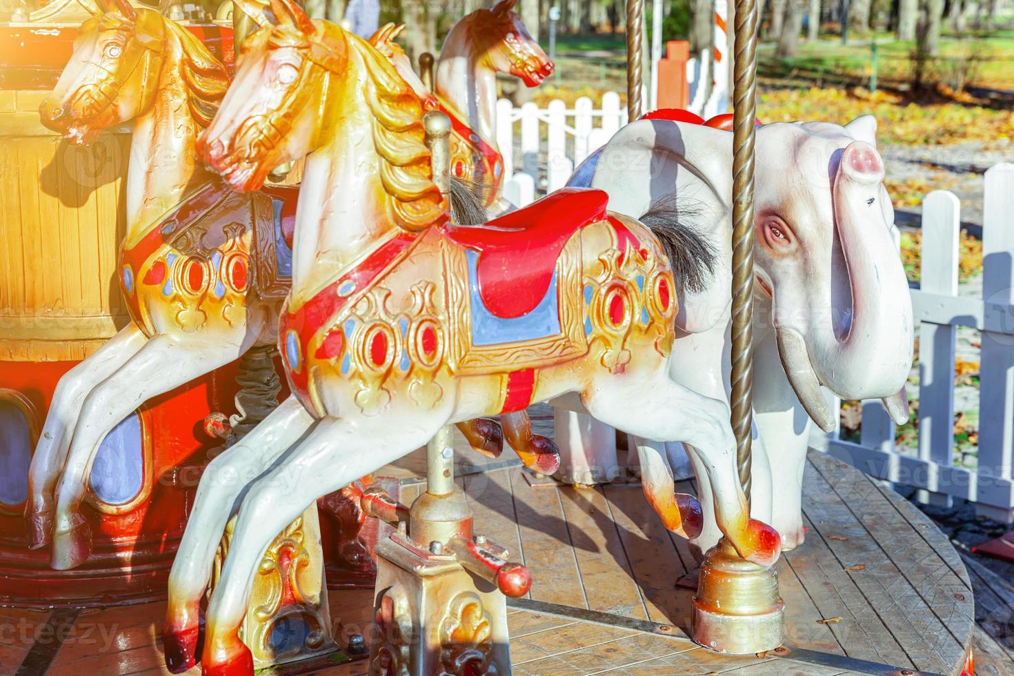 Vintage Merry-Go-Round flying horse carousel in amusement holliday park photo