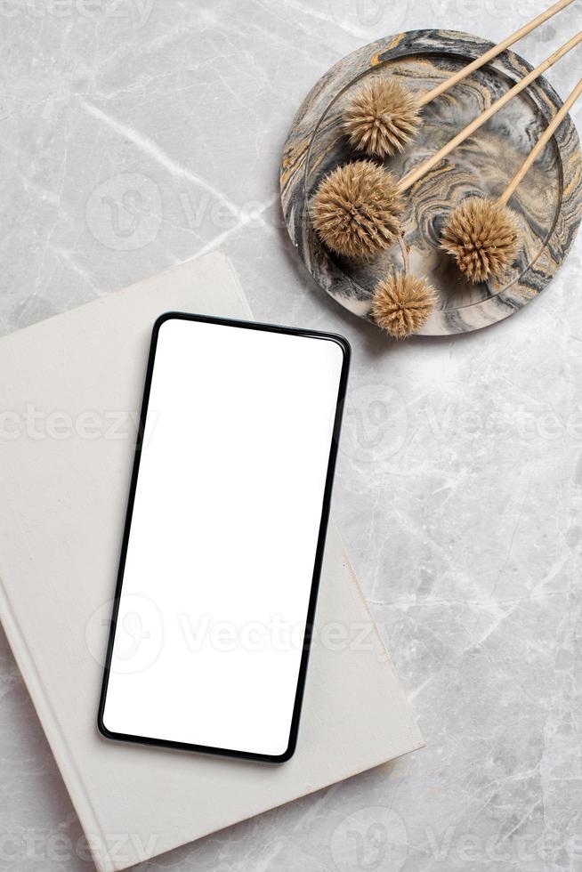 smartphone with isolated screen on marble desk photo