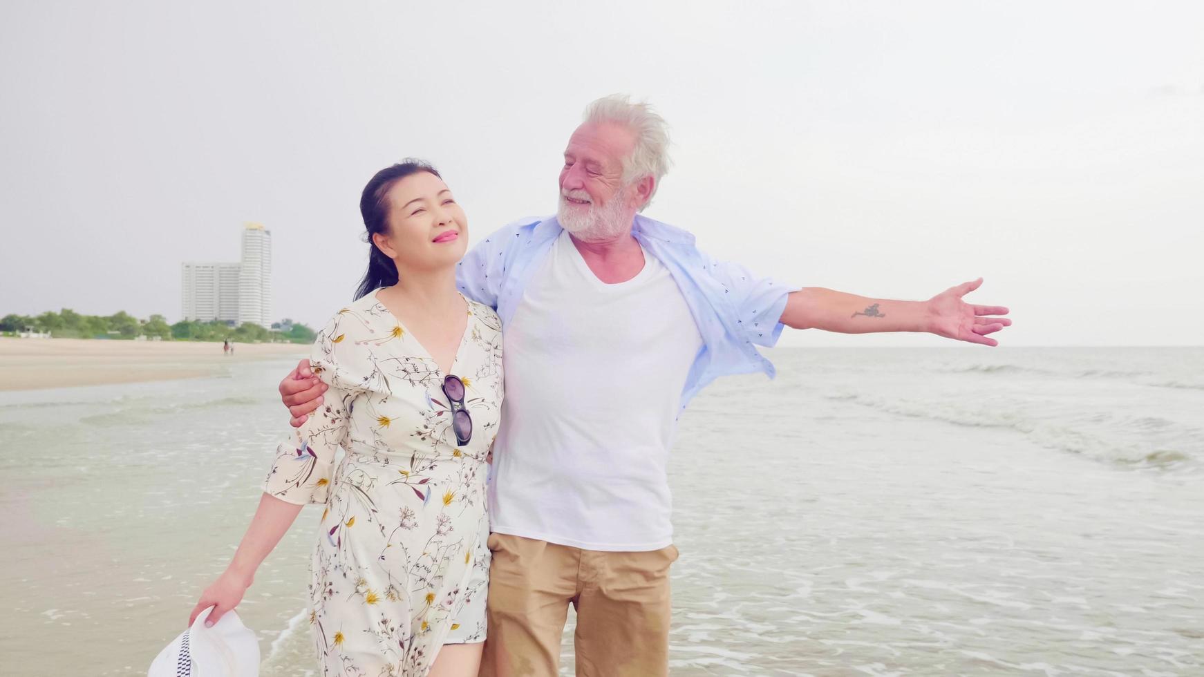 Happy couples walking together on the beach. photo