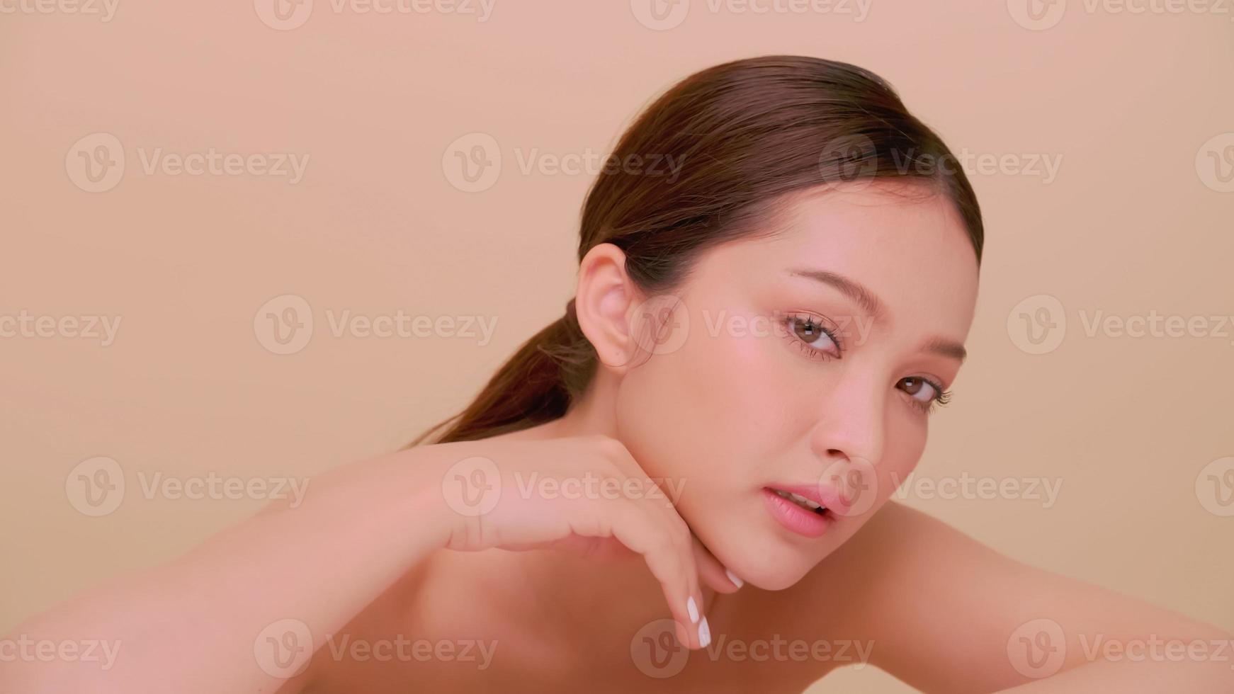 Beautiful face of Asian young woman with natural skin. Portrait of attractive girl with soft makeup and perfectly beautiful skin. photo