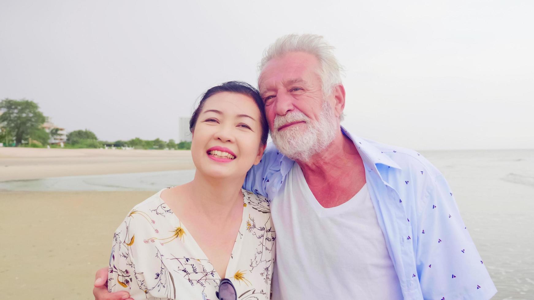 Happy couples standing together on the beach. photo