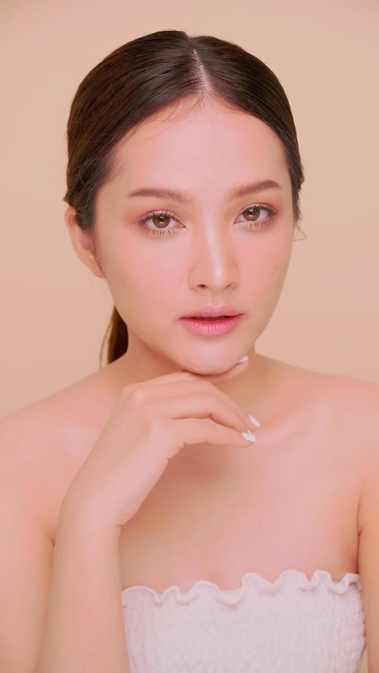 Beautiful face of Asian young woman with natural skin. Portrait of attractive girl with soft makeup and perfectly beautiful skin. photo