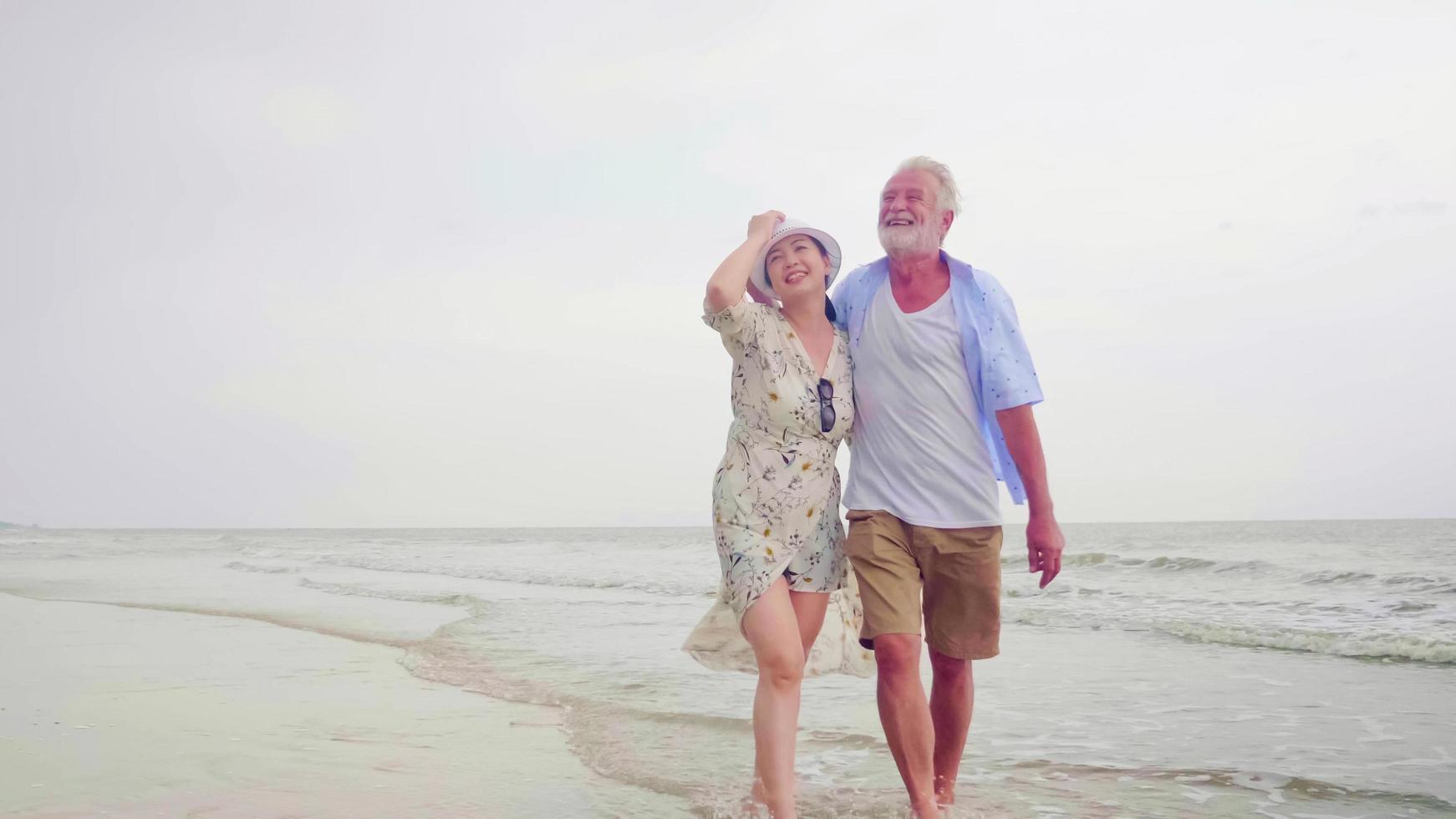 Happy couples walking together on the beach. photo