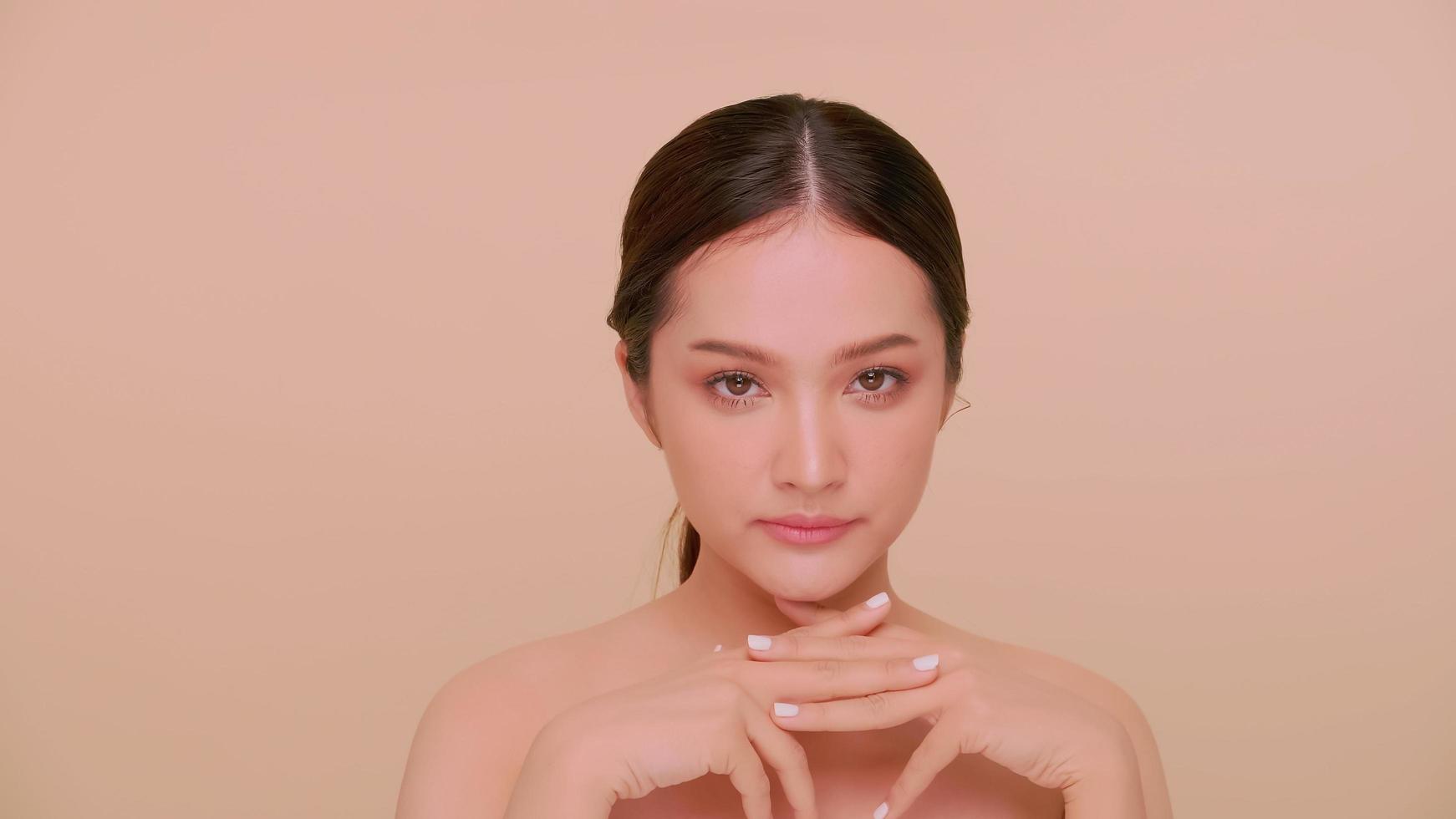 Beautiful face of Asian young woman with natural skin. Portrait of attractive girl with soft makeup and perfectly beautiful skin. photo