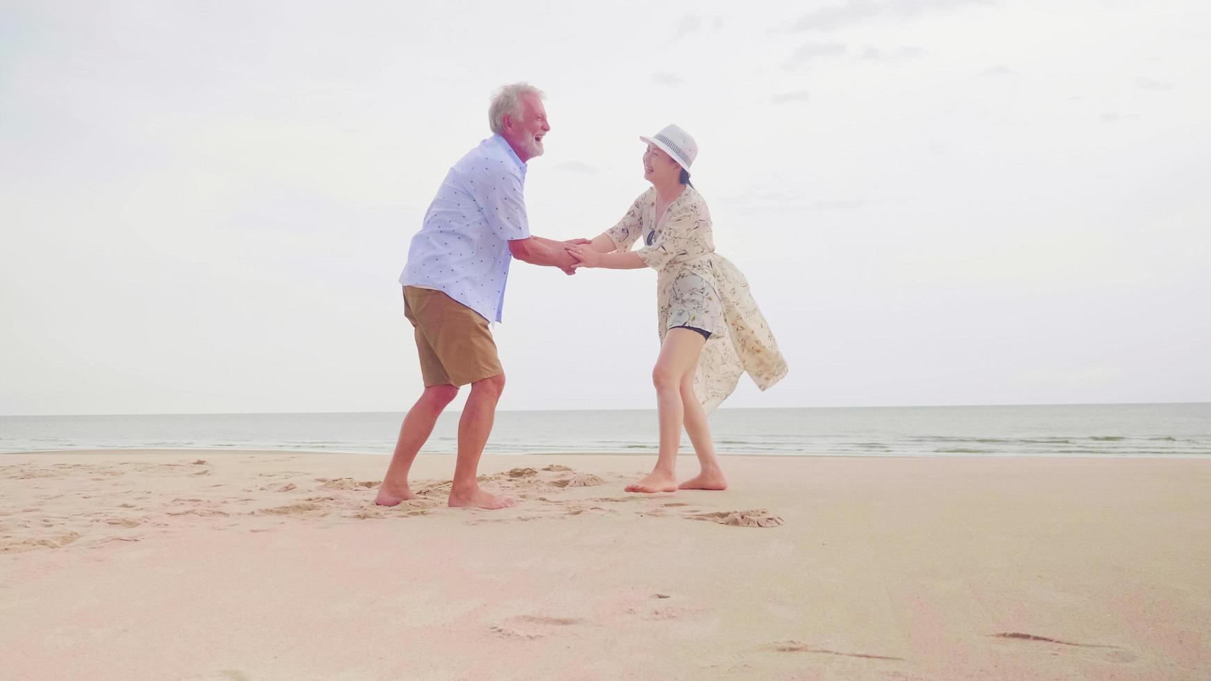 Happy couples standing and holding hands together on the beach. photo