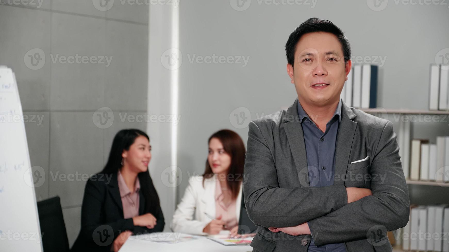 Portrait of young businessman standing in conference room. photo