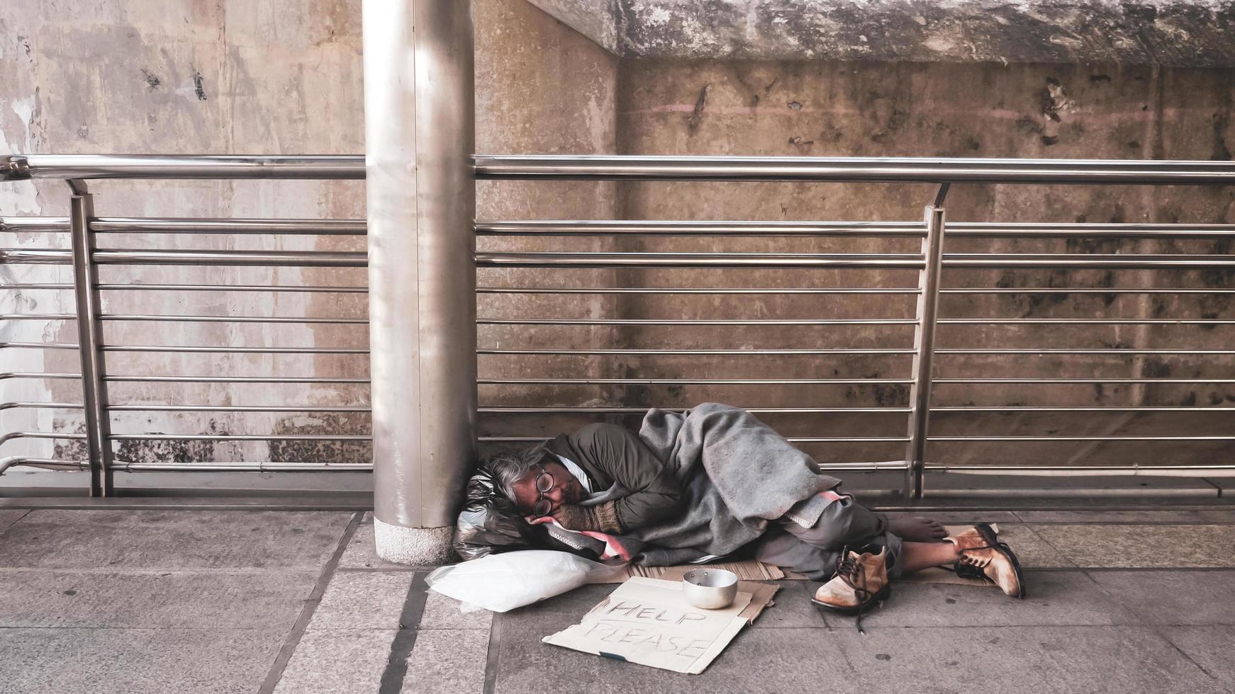 Homeless man sleeping on outdoor floor. photo