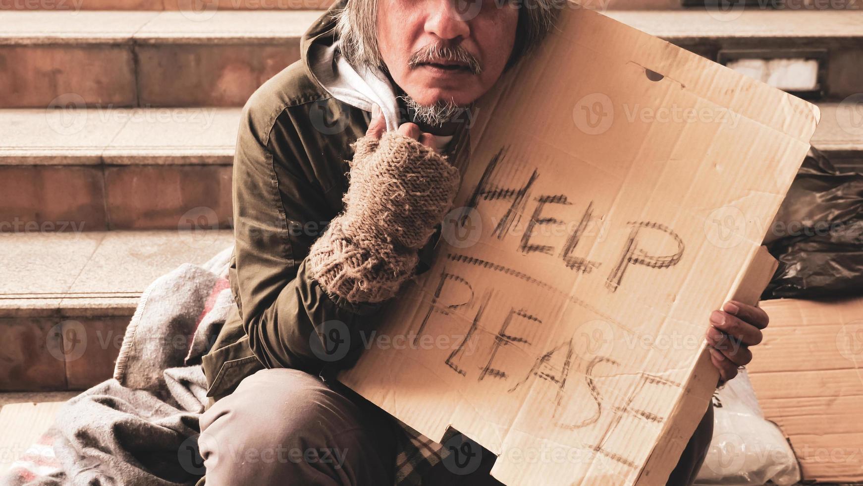 Homeless man sitting on stairs. photo