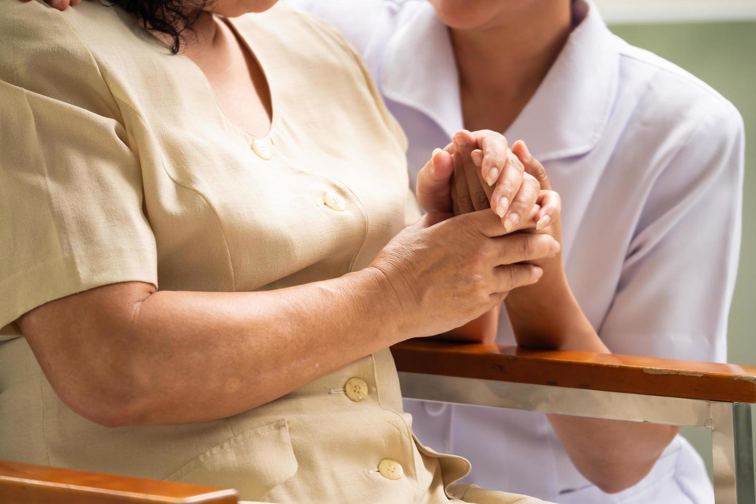 Close up of nurse comforting female patient in the room. photo