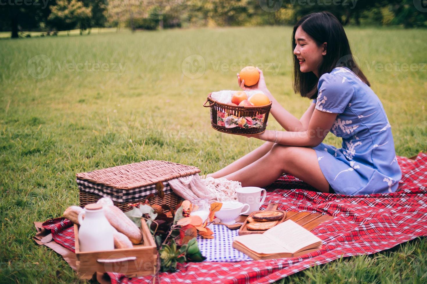 Close up of woman enjoying picnic in a park. photo