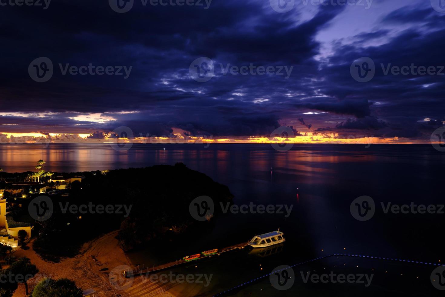 Burning sunset behind dark clouds at Tiger Beach photo