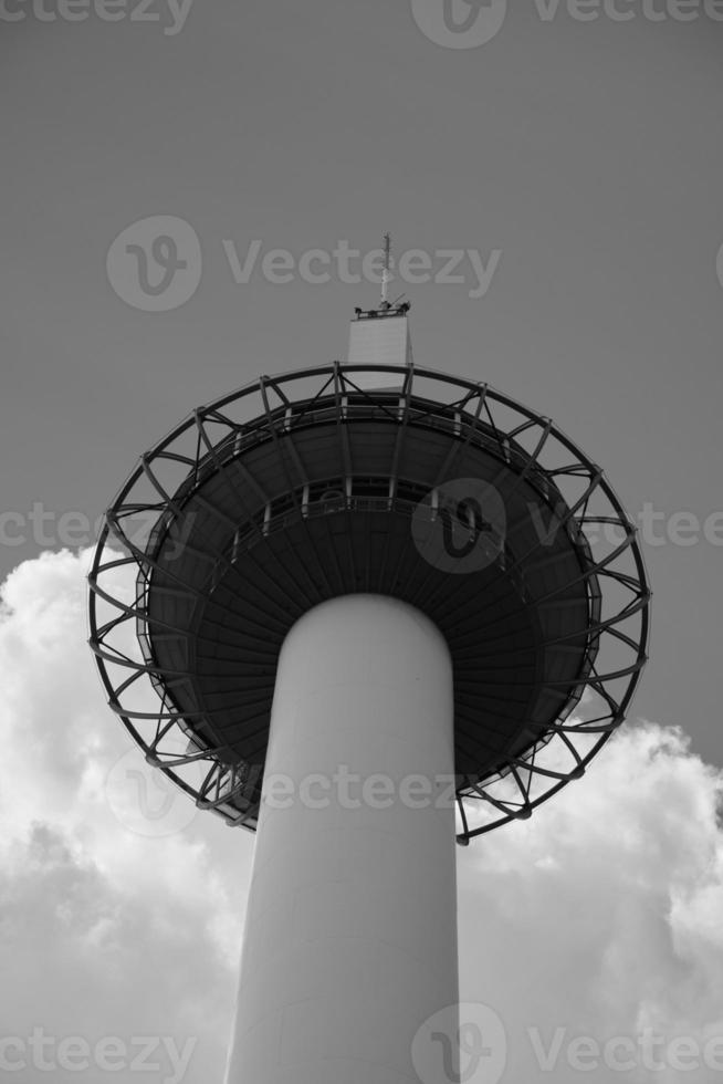 Top of Kyoto Tower from below in black and white photo