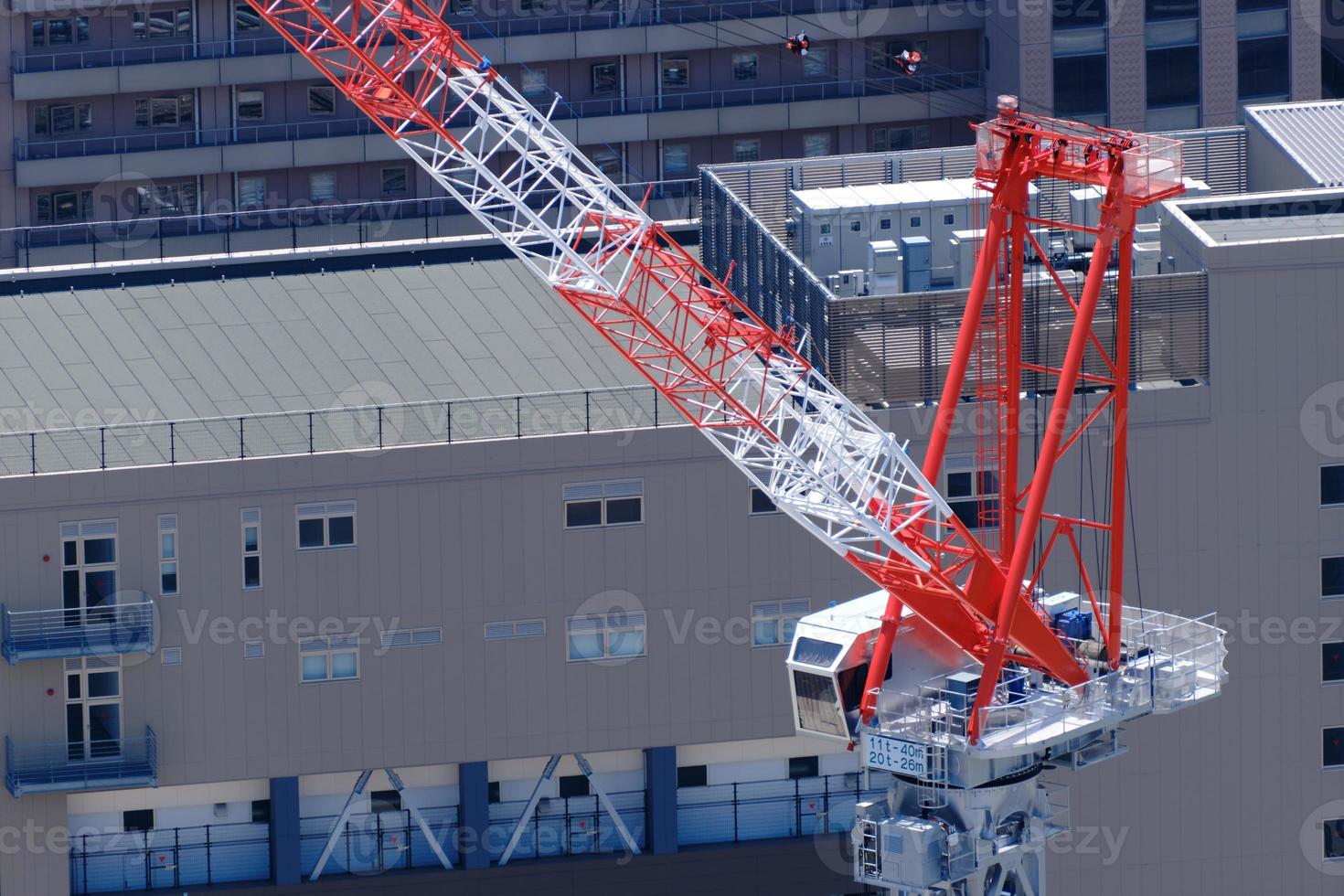 Tower crane with buildings in background from high angle photo