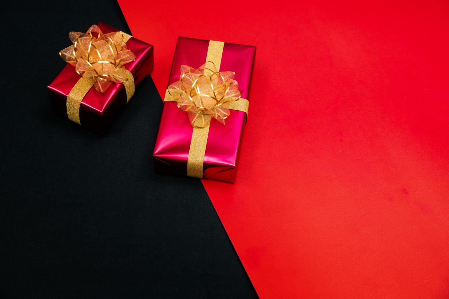 black gift box with black ribbons isolated on black background photo