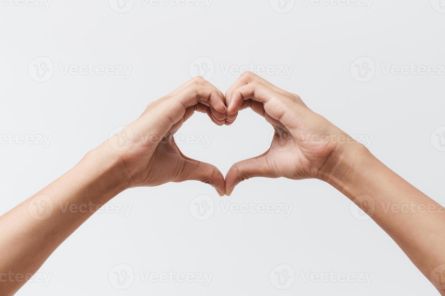 Man hands making a heart shape on a white isolated background photo