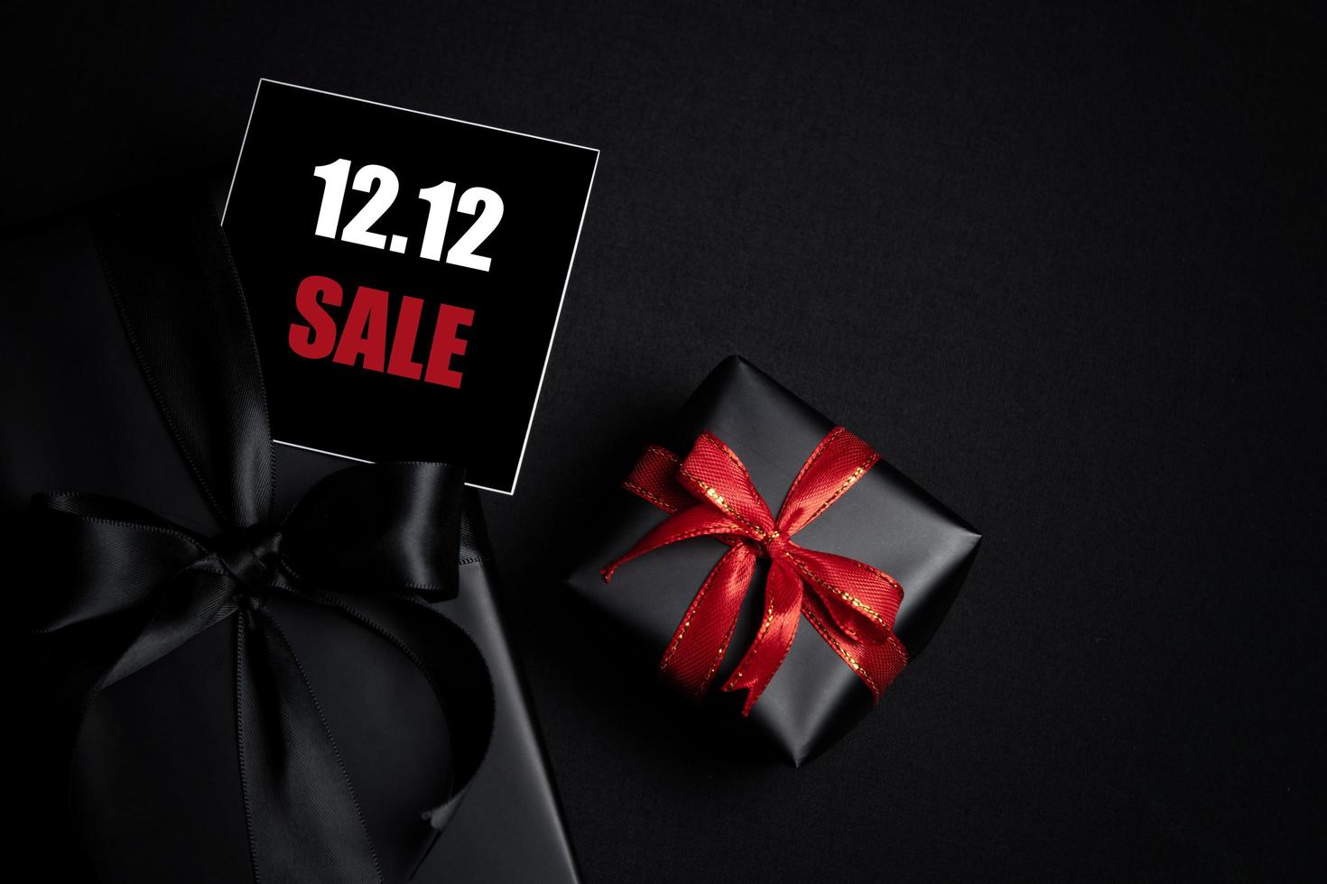 Top view of black gift box with black background with copy space for text 12.12 singles day sale. photo