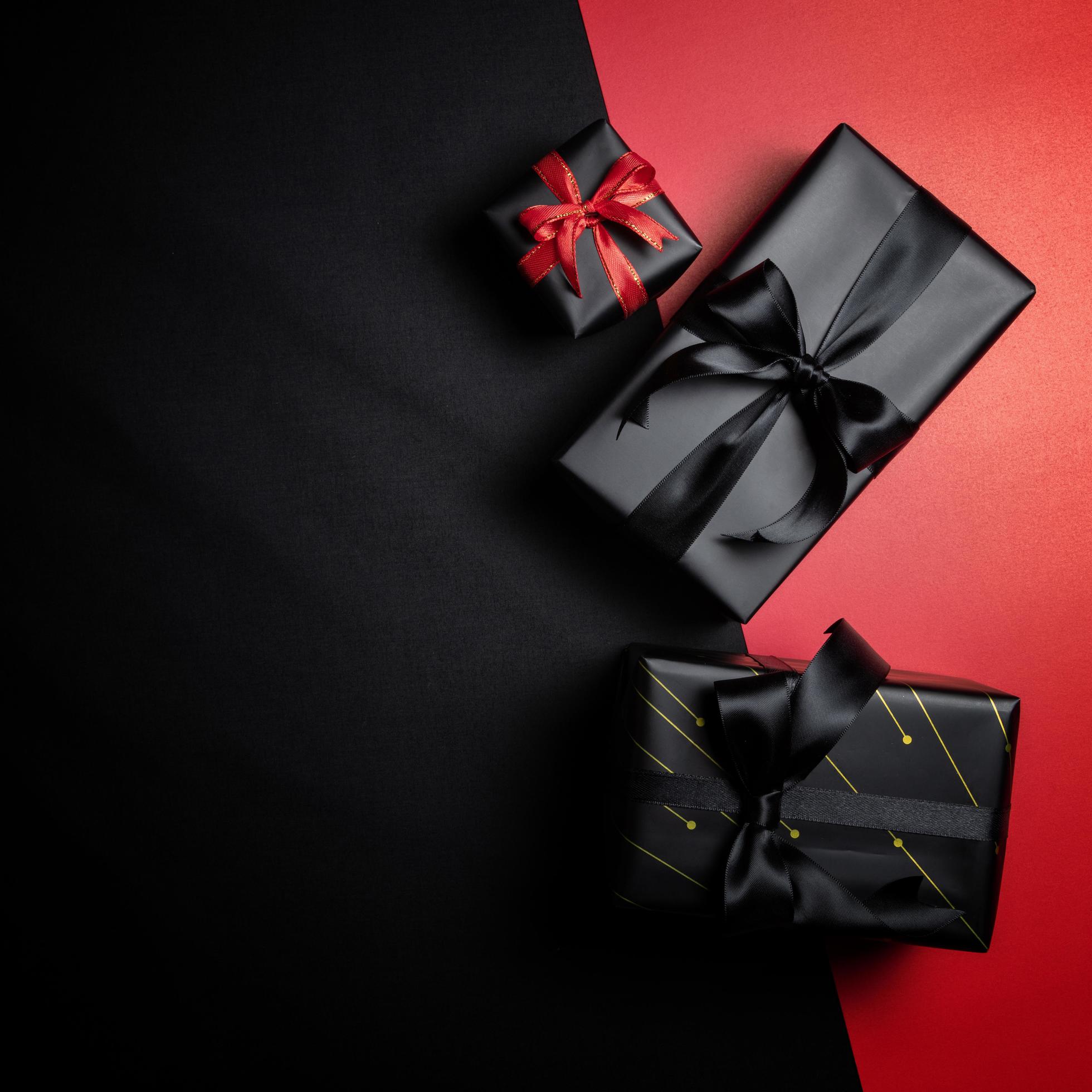 black gift box with black ribbons isolated on black background 11557660