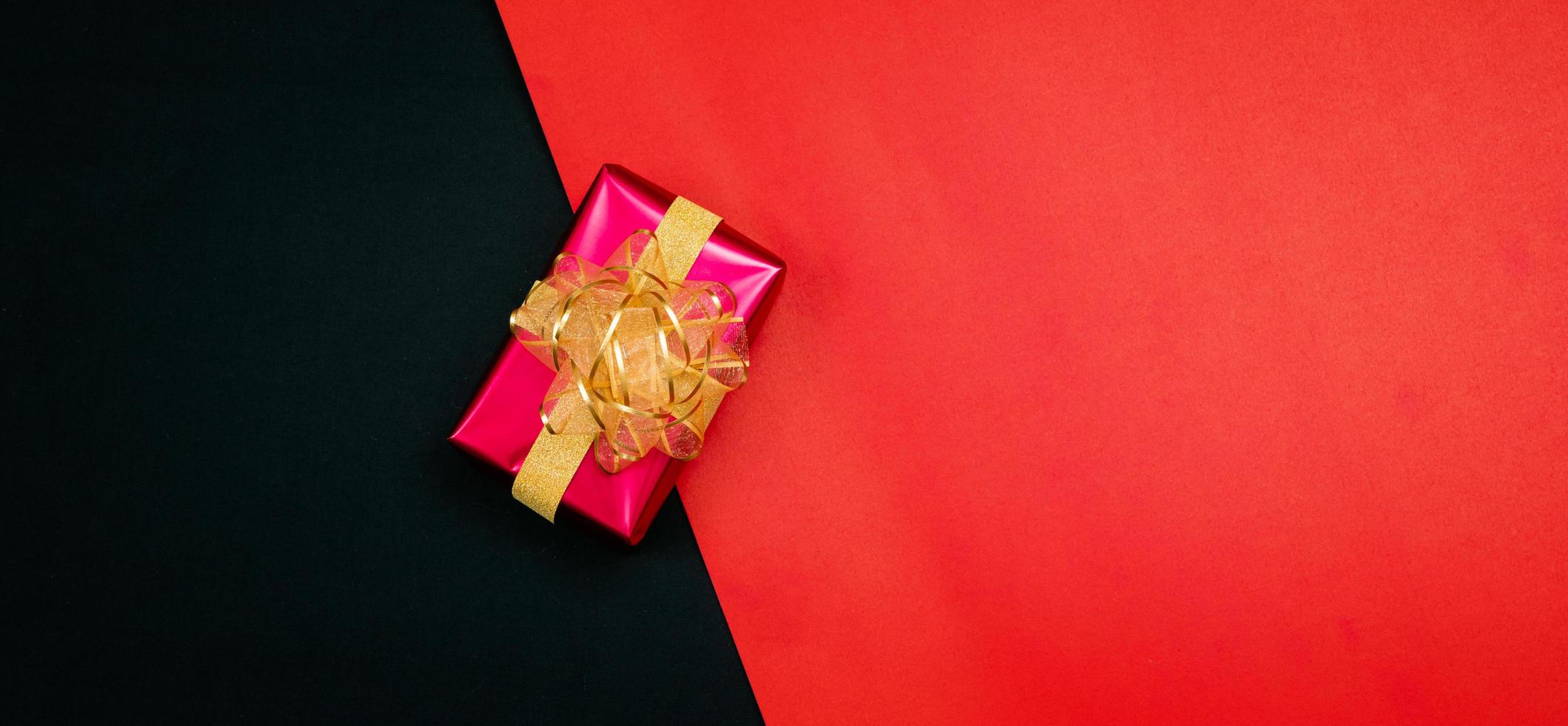 black gift box with black ribbons isolated on black background 11557749