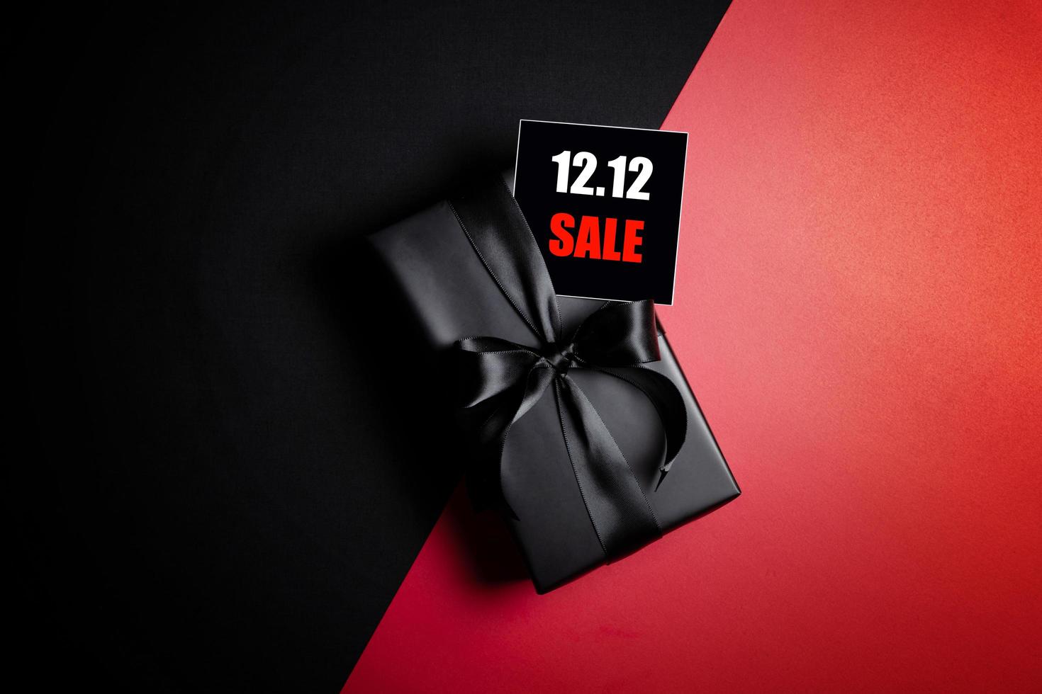 Top view of black gift box with black background with copy space for text 12.12 singles day sale. photo