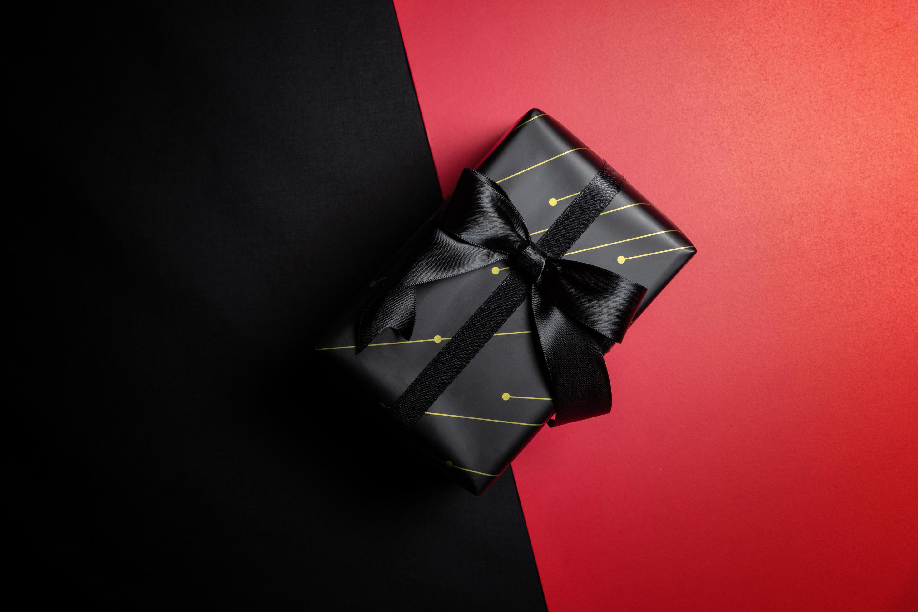black gift box with black ribbons isolated on black background 11558019
