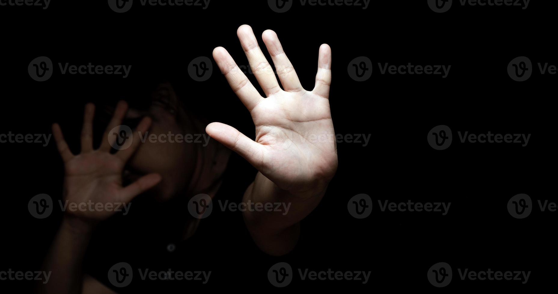 Woman with her hand extended signaling to stop photo