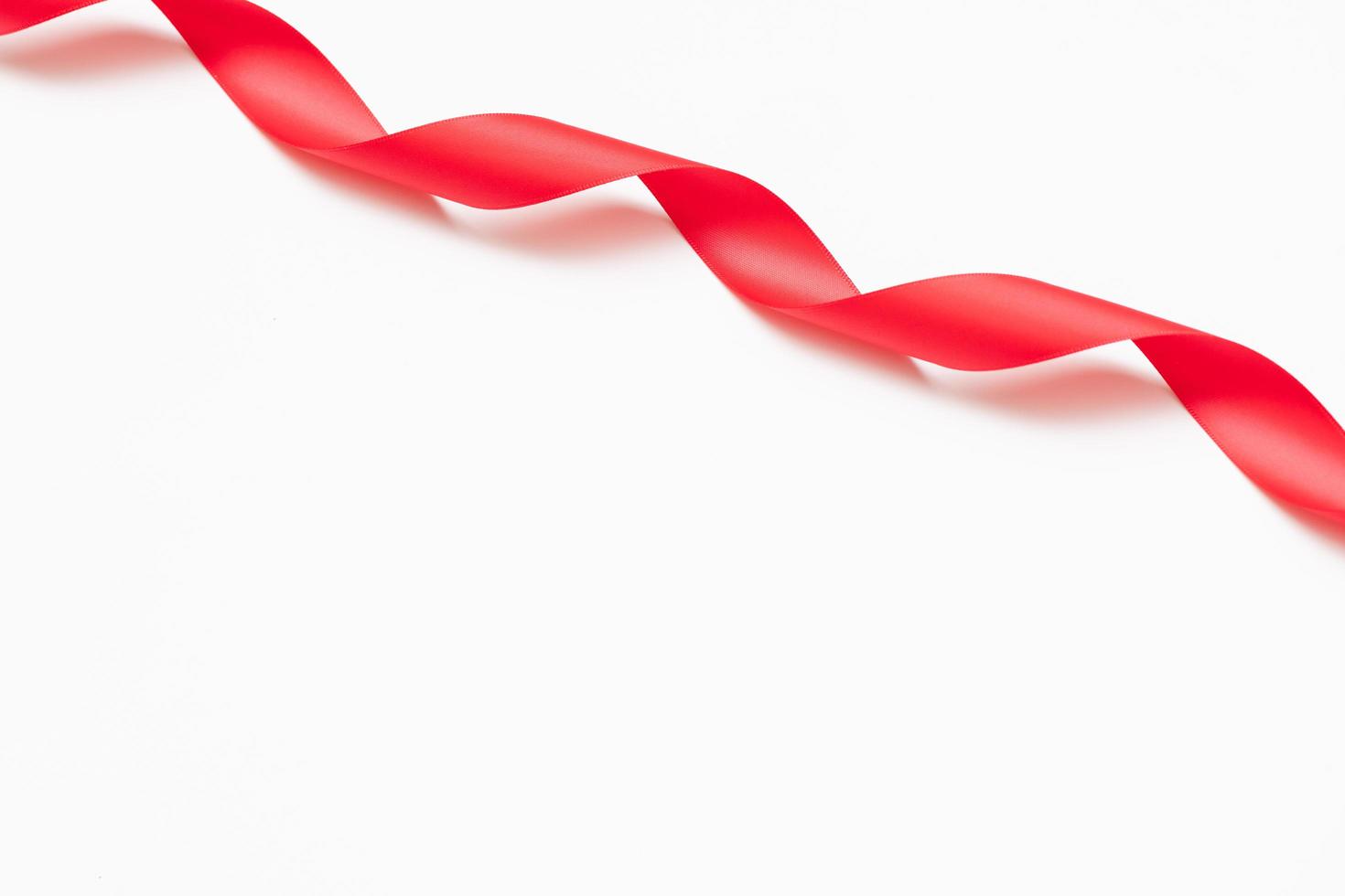 Curly red ribbons on white background photo