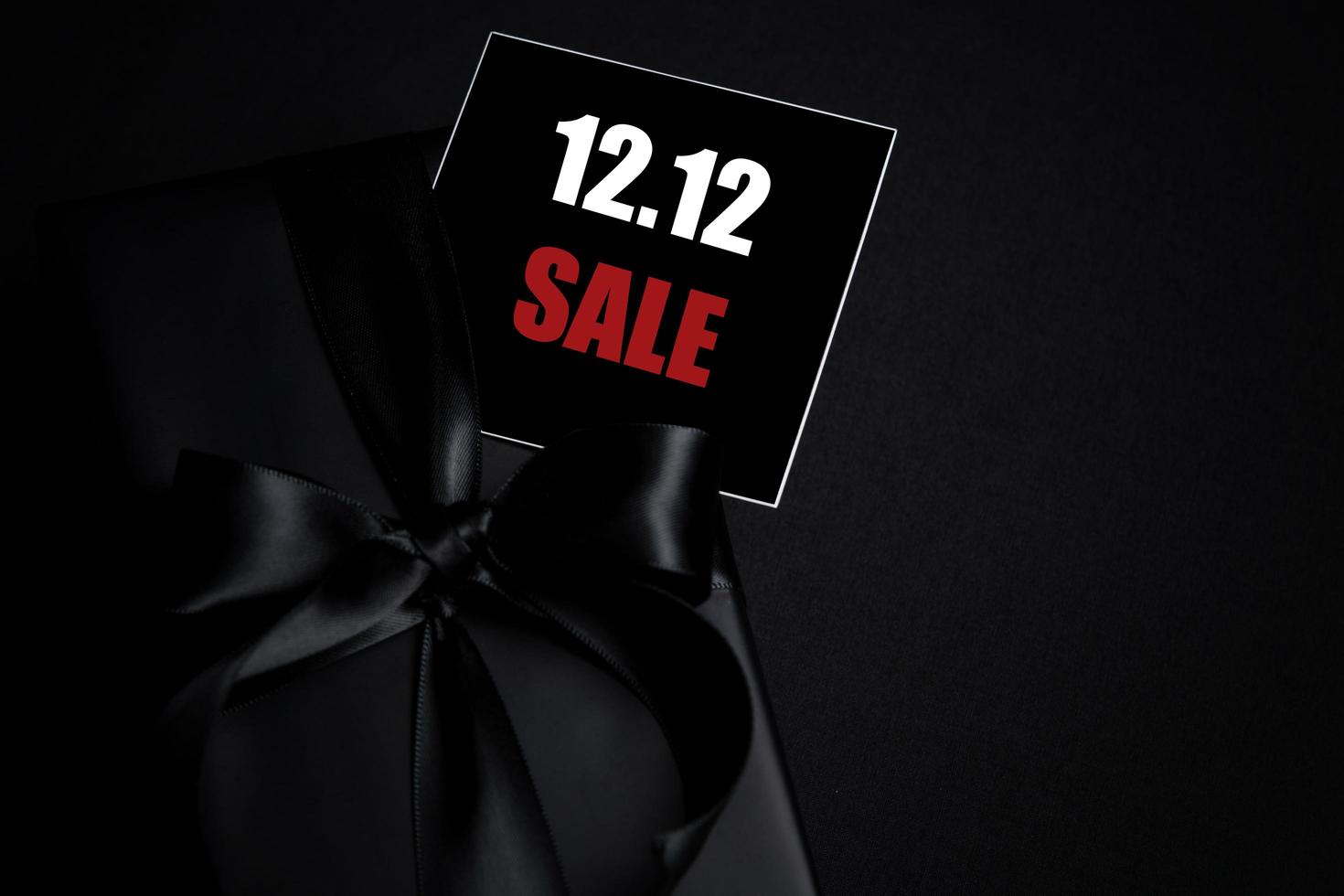 Top view of black gift box with black background with copy space for text 12.12 singles day sale. photo