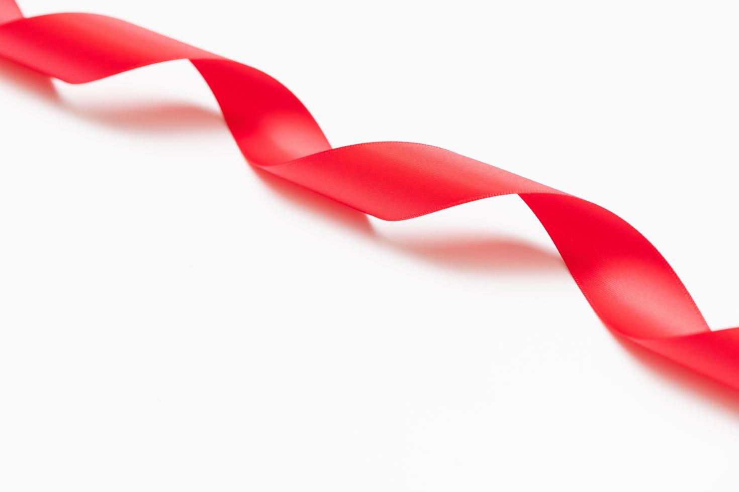 Curly red ribbons on white background photo