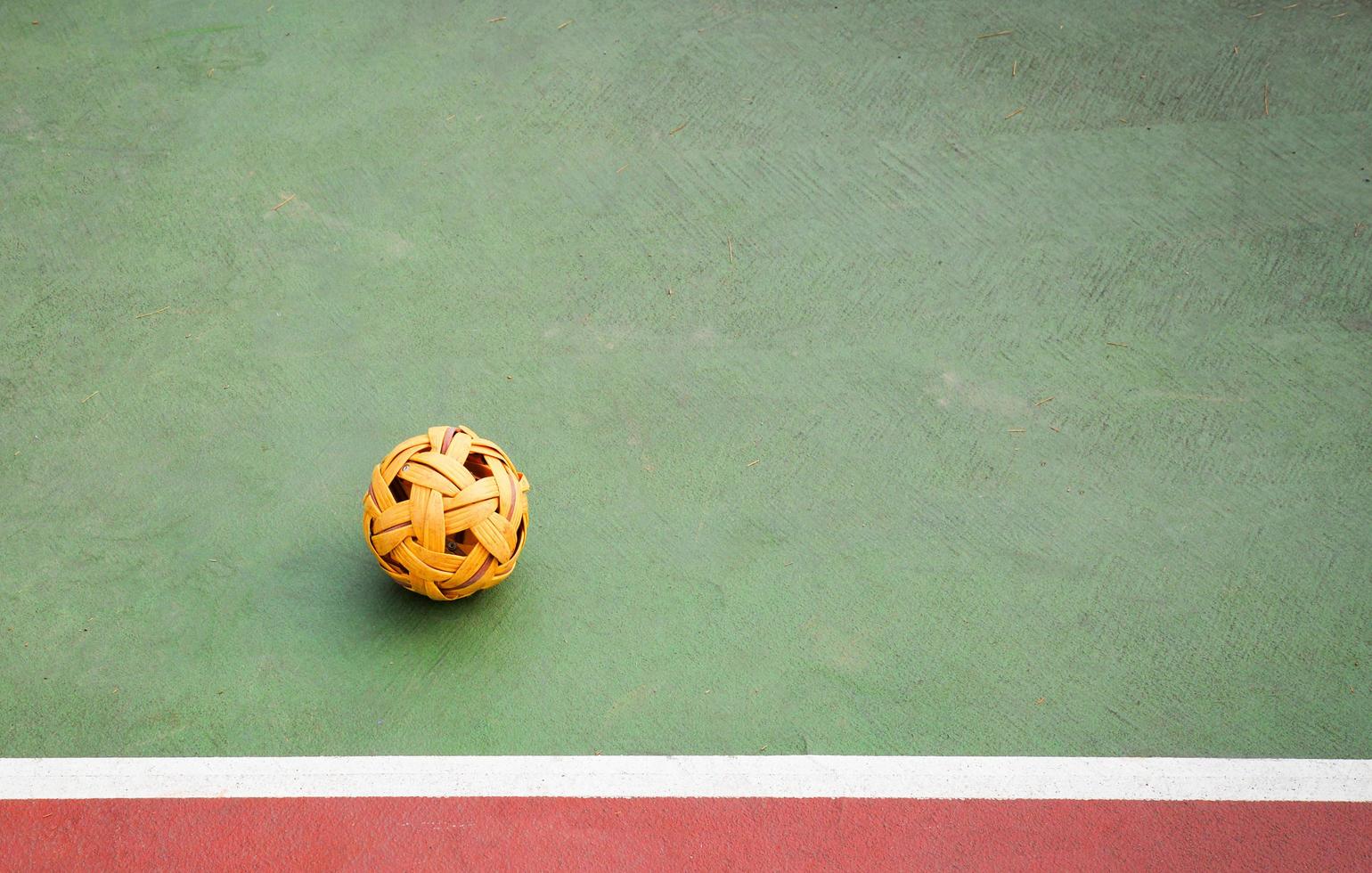 Sepak Takraw ball or rattan ball on field of sepak takraw court with line on sport outdoors photo