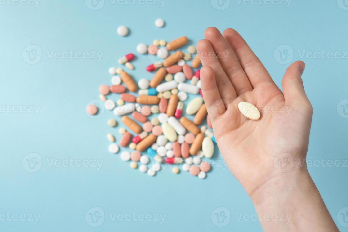 Palm with pill close up. Teenager's hand with medicines. The concept of drug selection, top view photo