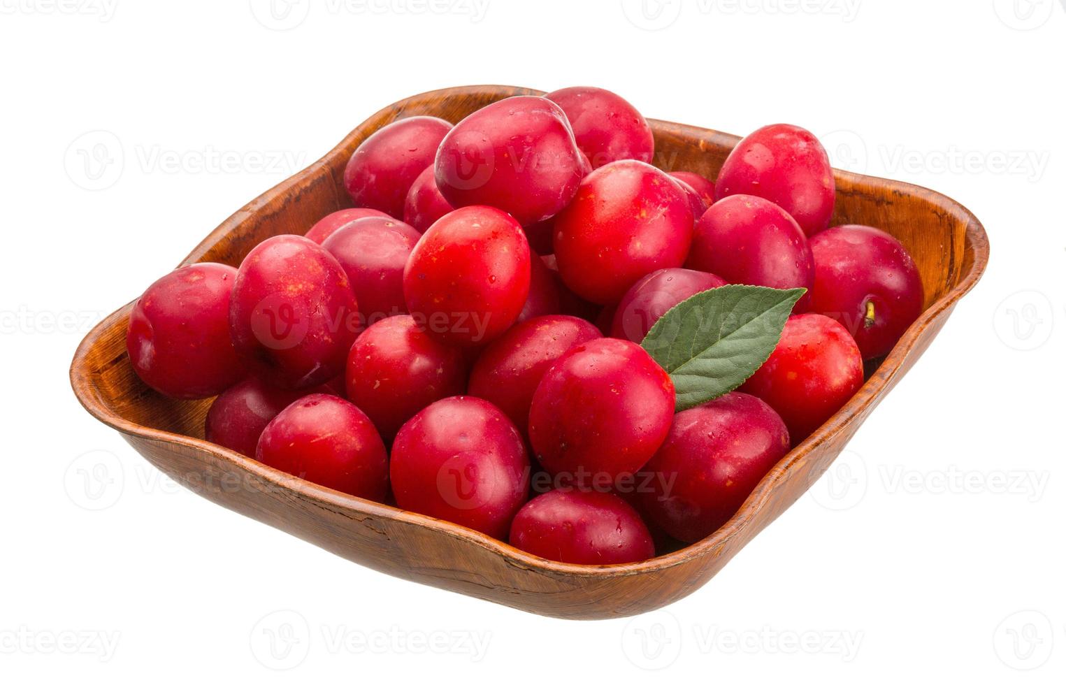 Damson plum in a bowl on white background photo