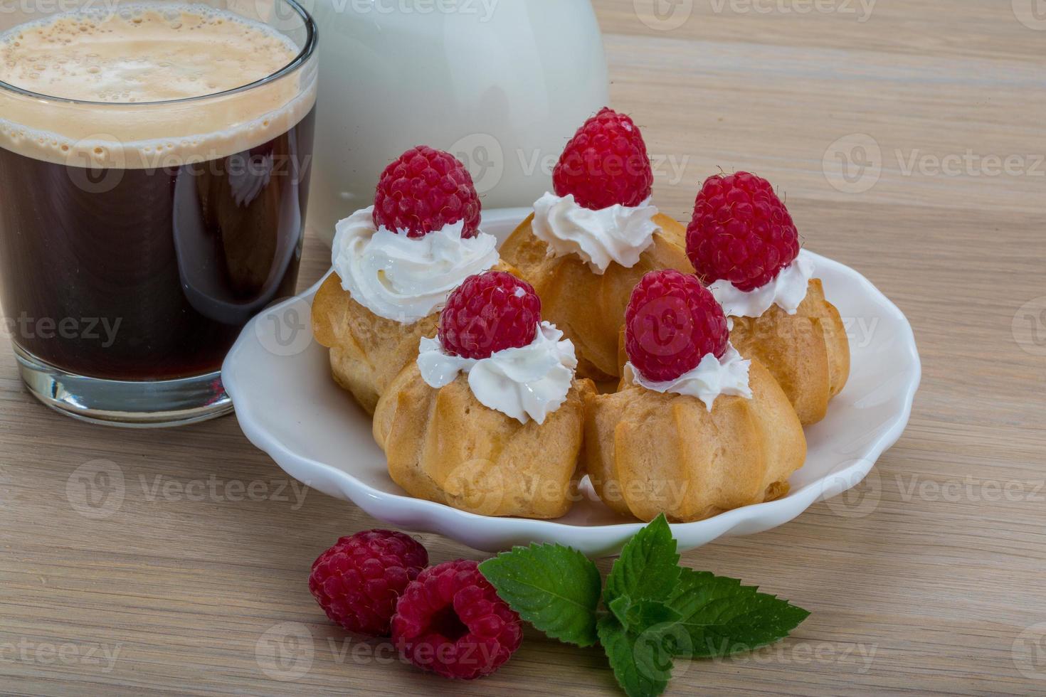 Profiterole with raspberry photo