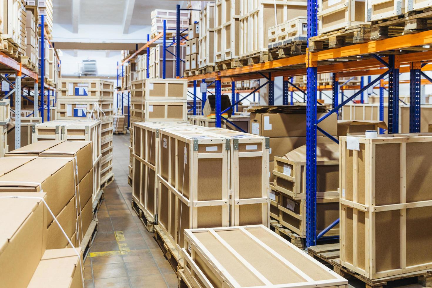 Rows of shelves filled with cardboard boxes. Warehouse transport and logistics company. Storage of retail. Large hangar. Big containers. Goods inside. photo