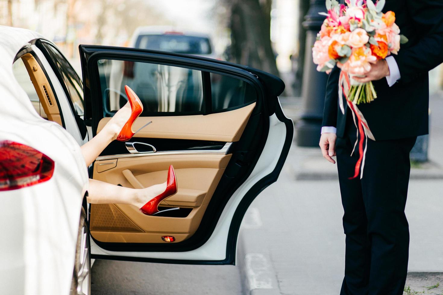 Man with bouquet waiting for woman photo