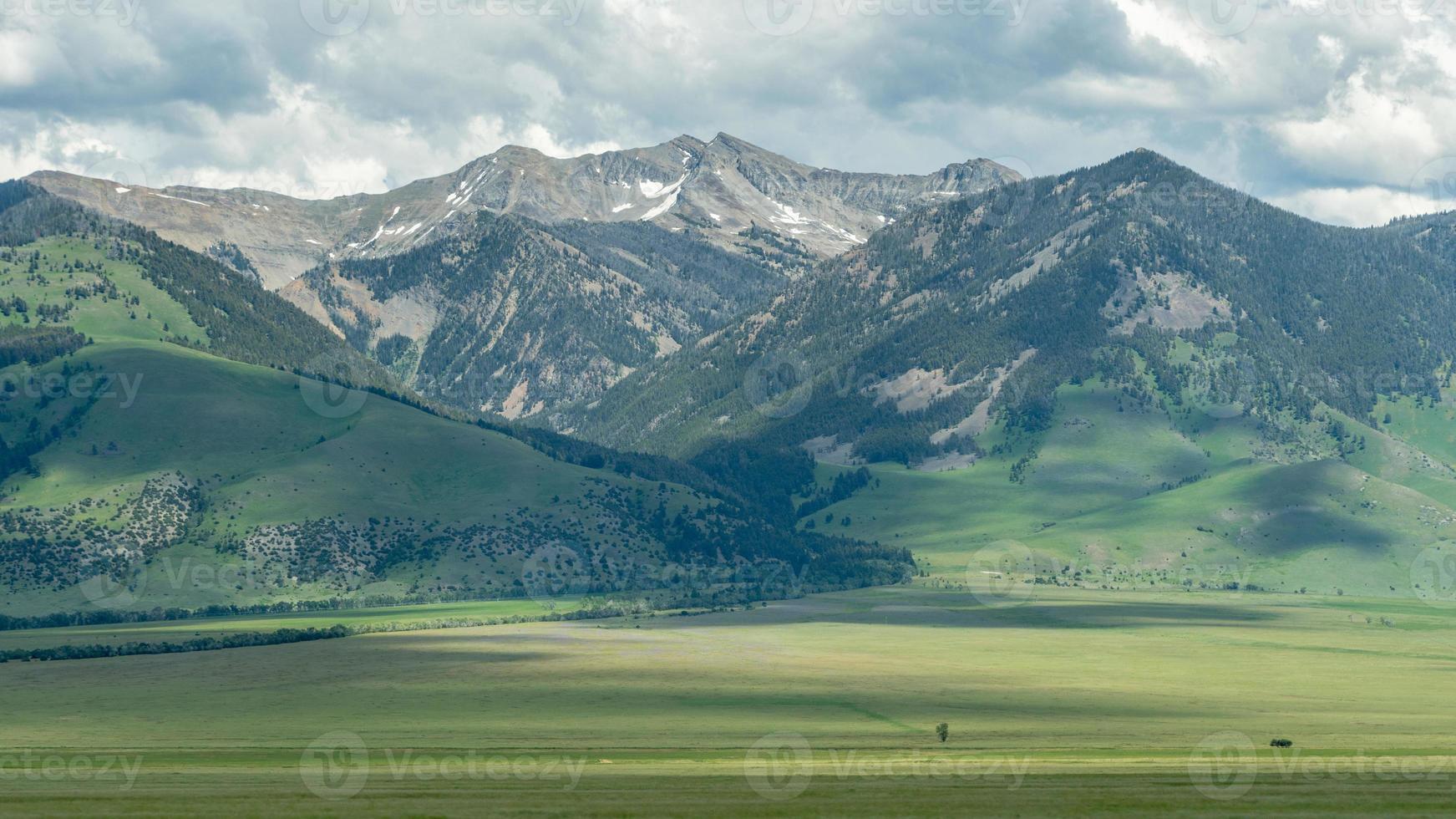 A vast, mountainous landscape under a cloudy sky in western Montana. photo