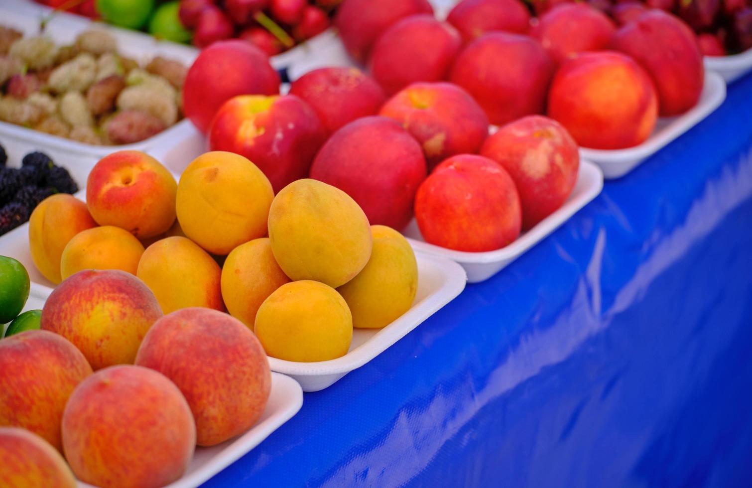 Fresh peaches and apricots in the market photo