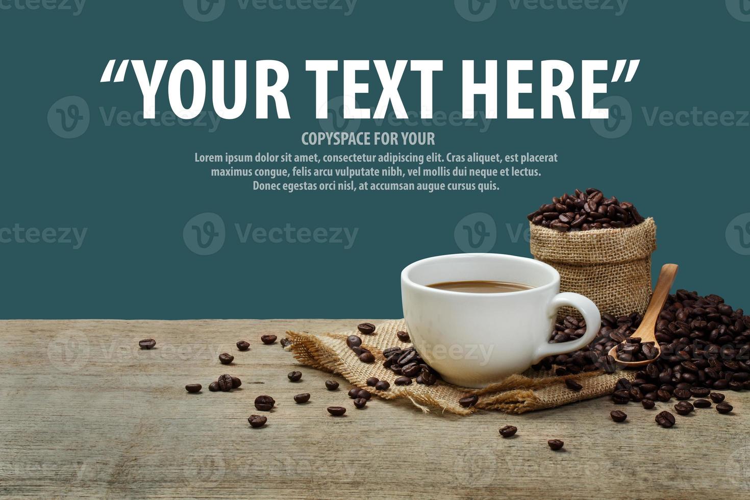 Hot Coffee cup with Coffee beans on the wooden table and the navy blue background with copyspace for your text. photo