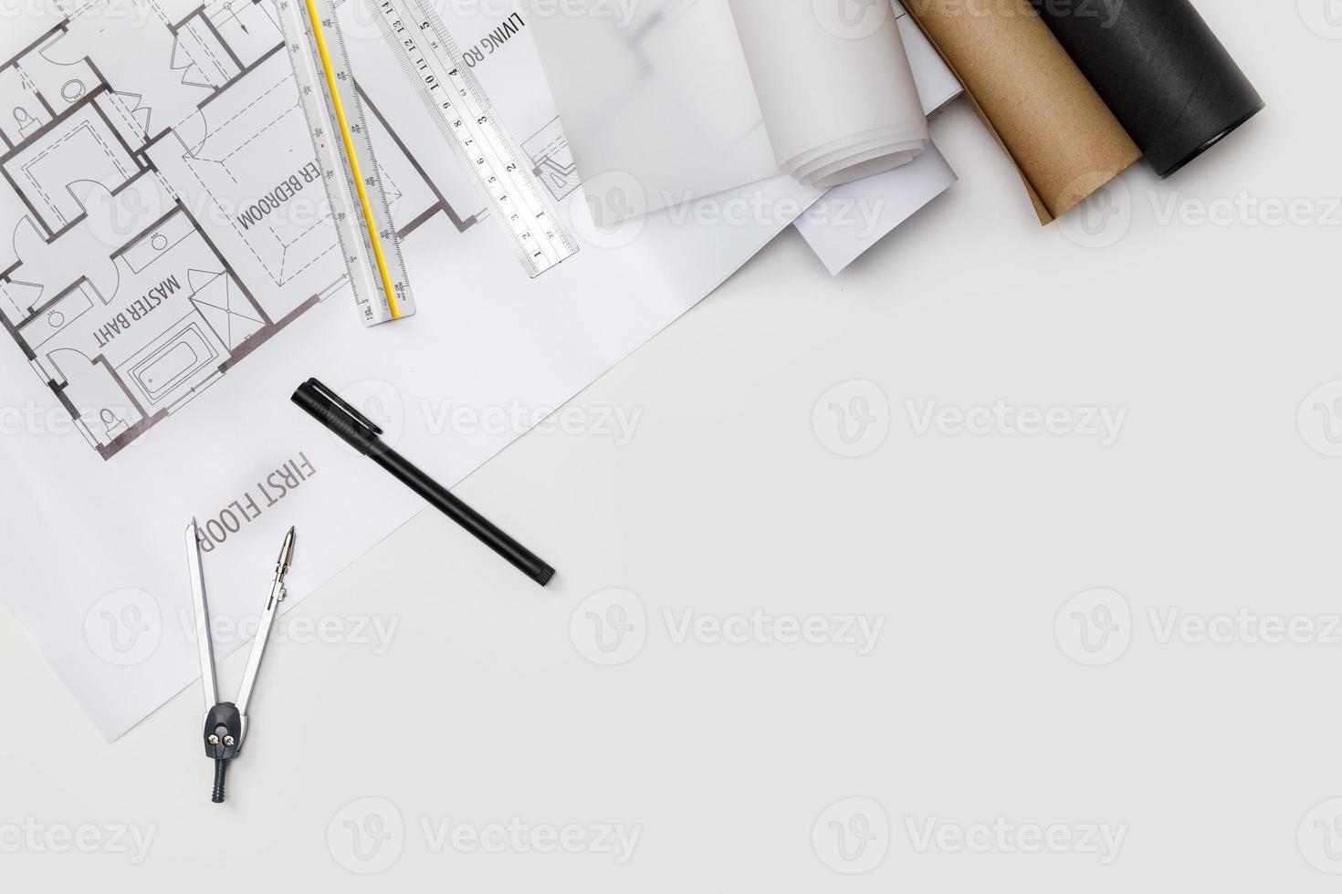 Top view workspace mockup of architectural project with laptop computer, architectural project plan, engineering tools and office supplies on white desk empty space for your text isolated on white photo