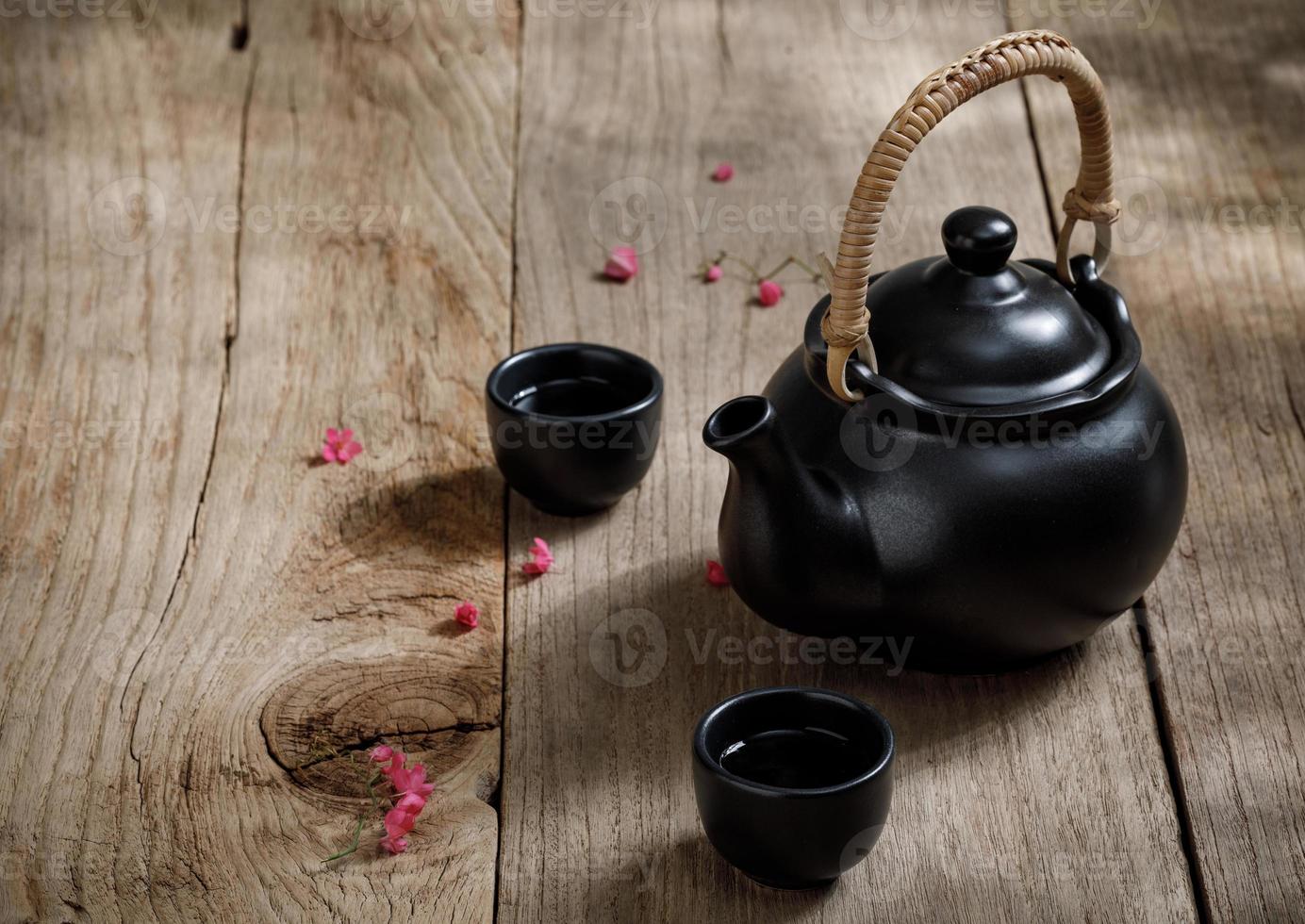 Cup of hot tea with steaming jugs on the wooden table background with copyspace for your text, Chinese style photo