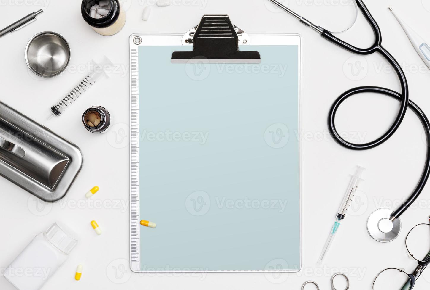 Doctor medical equipment white backgroud with stethoscope, medical documents, thermometer, syringe and pills with copy space mockup template photo