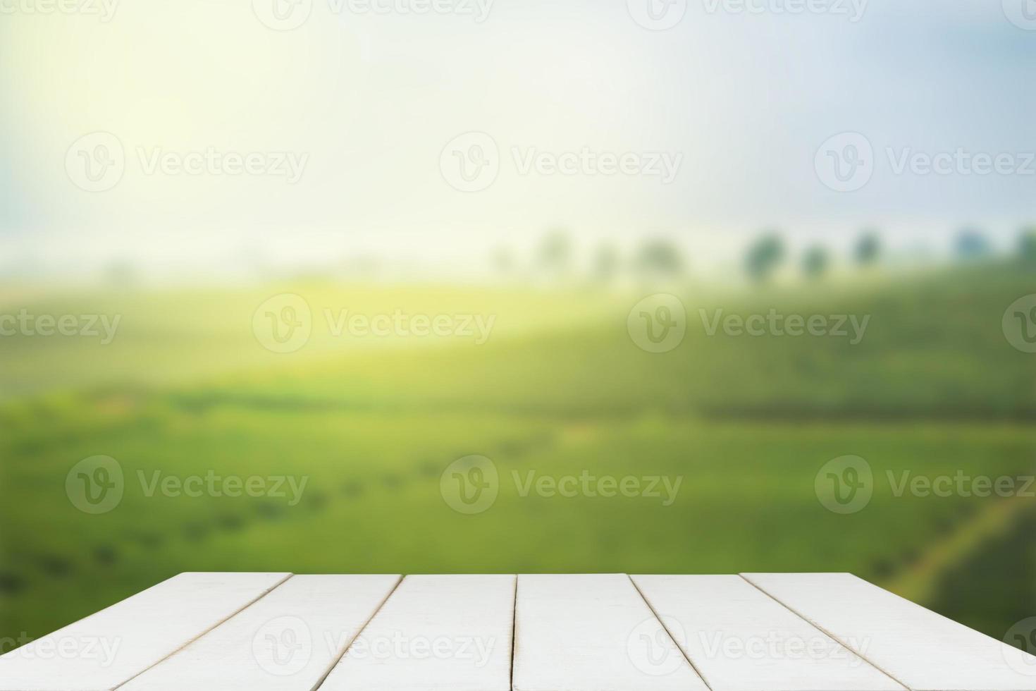 Empty wooden table with view of mountain or wooden desk with plantation nature with bokeh background, copy space for your text photo